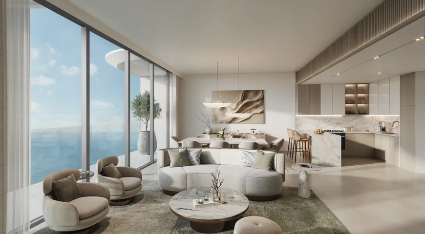 Living, dining and kitchen space at Hilton Residences with full-height glazing opening to the sea